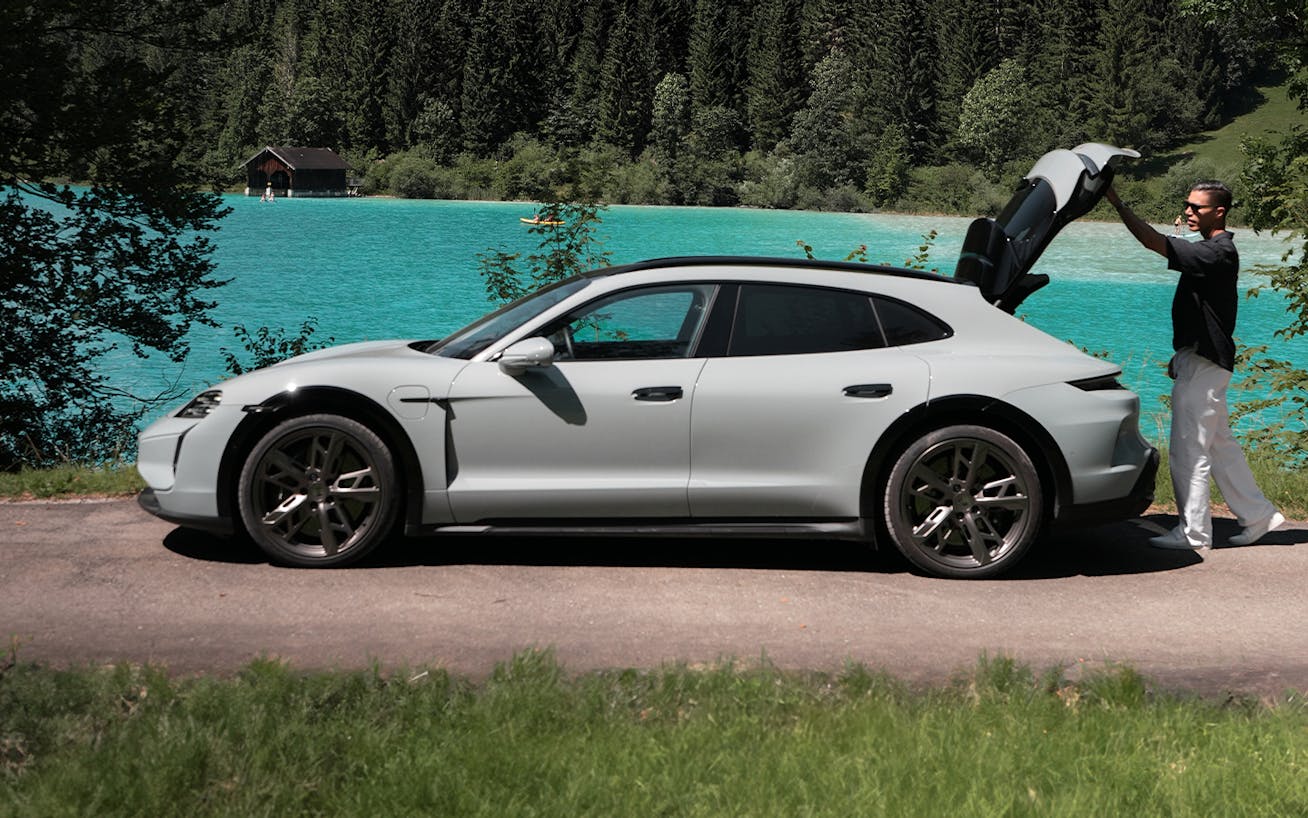 Man opening boot of Porsche Taycan Turbo S Cross Turismo