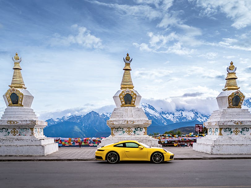 Porsche 911 Carrera against backdrop of mountains in Shangri-La, China 