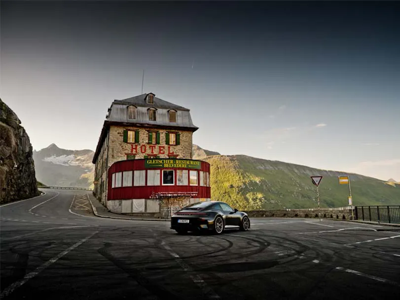 Porsche GT3 Bergsport driving past the historic Hotel Belvédère on the iconic Furka Pass in Switzerland