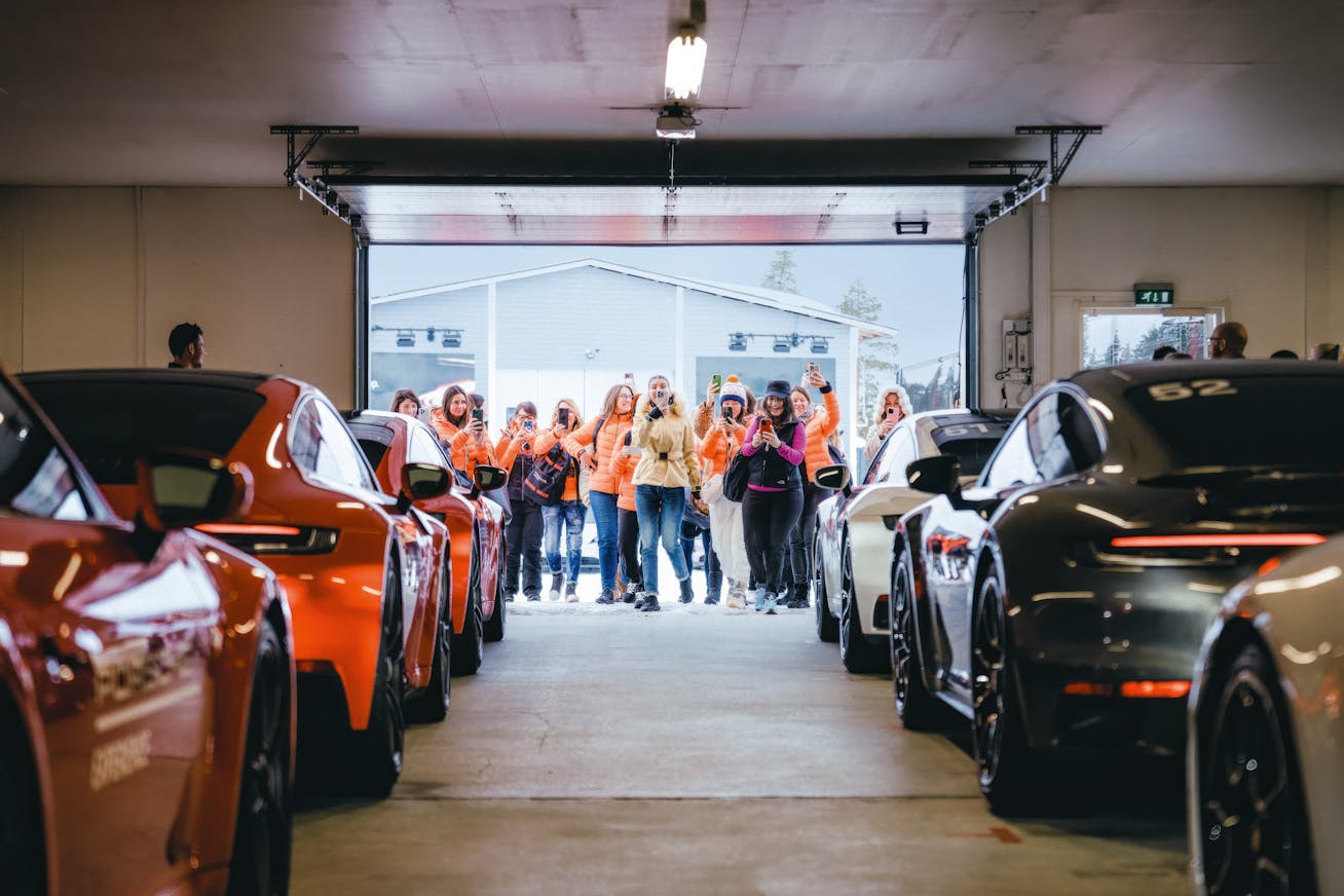 Hangar at Porsche Arctic Center filled with six Porsche sports cars