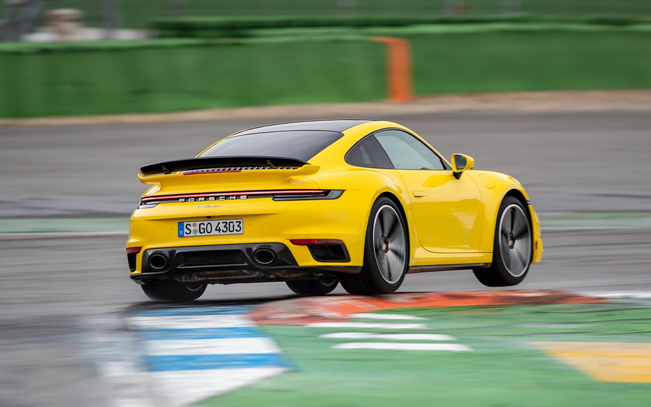 Yellow Porsche 911 Turbo (type 992) cornering on track