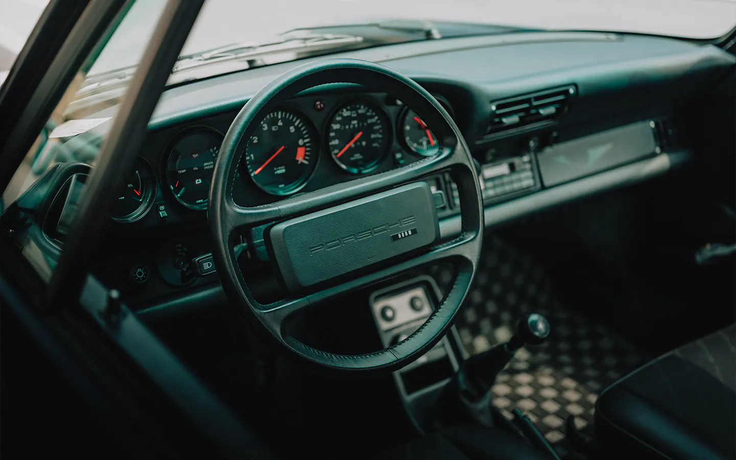 Dashboard close-up of black Porsche 911 Carrera S/C