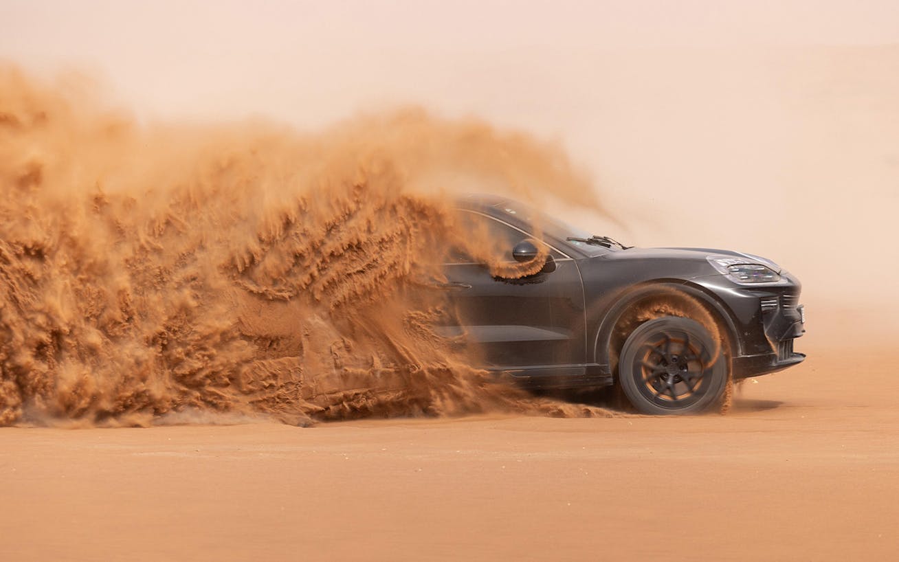 Porsche Cayenne Electric prototype kicking up sand in Dubai desert