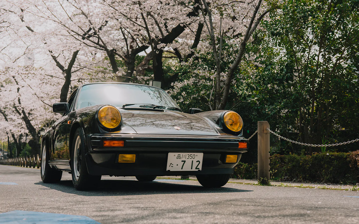 Black Porsche 911 Carrera S/C driving on Tokyo street