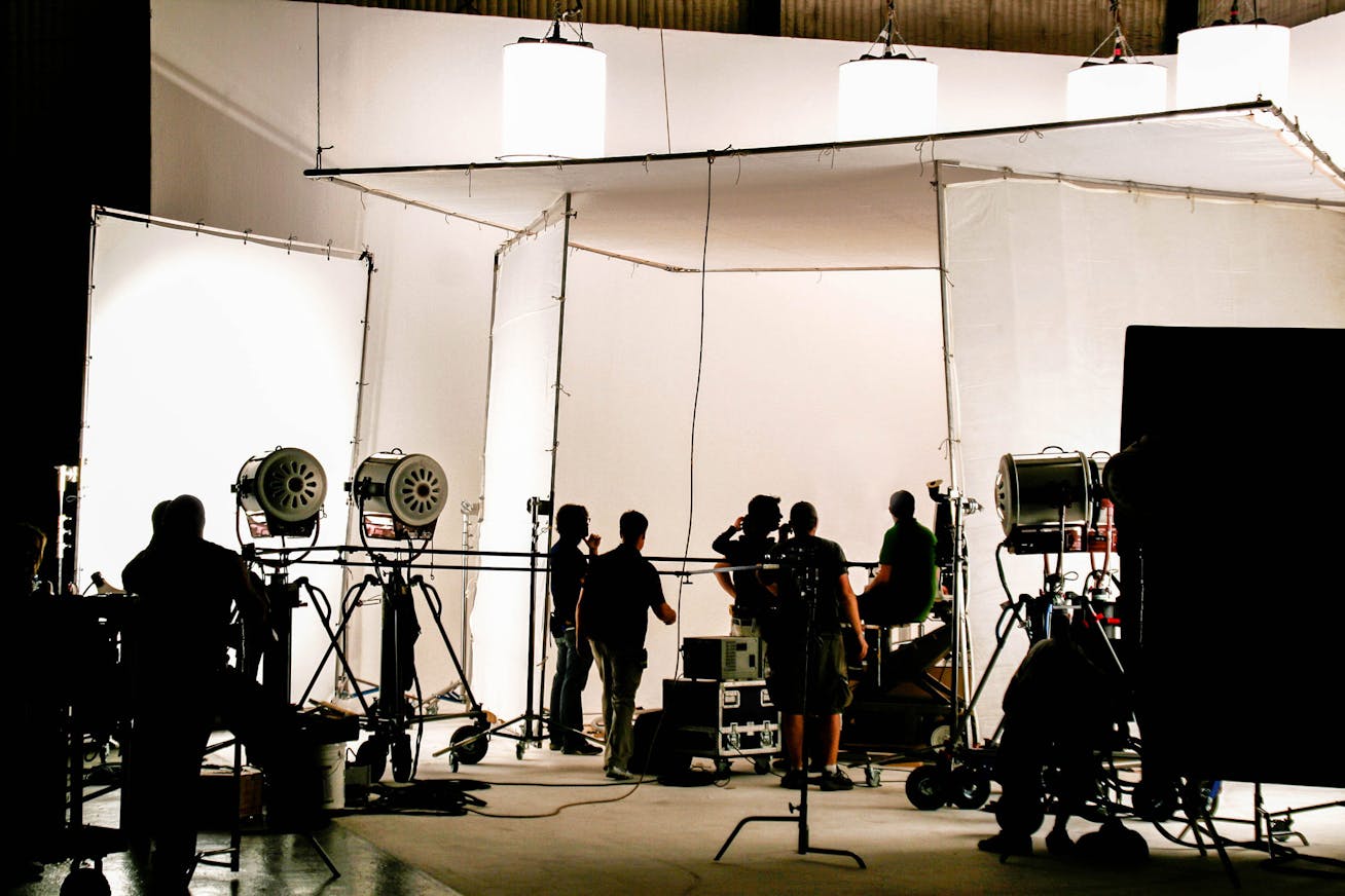 Film crew in production hall with camera