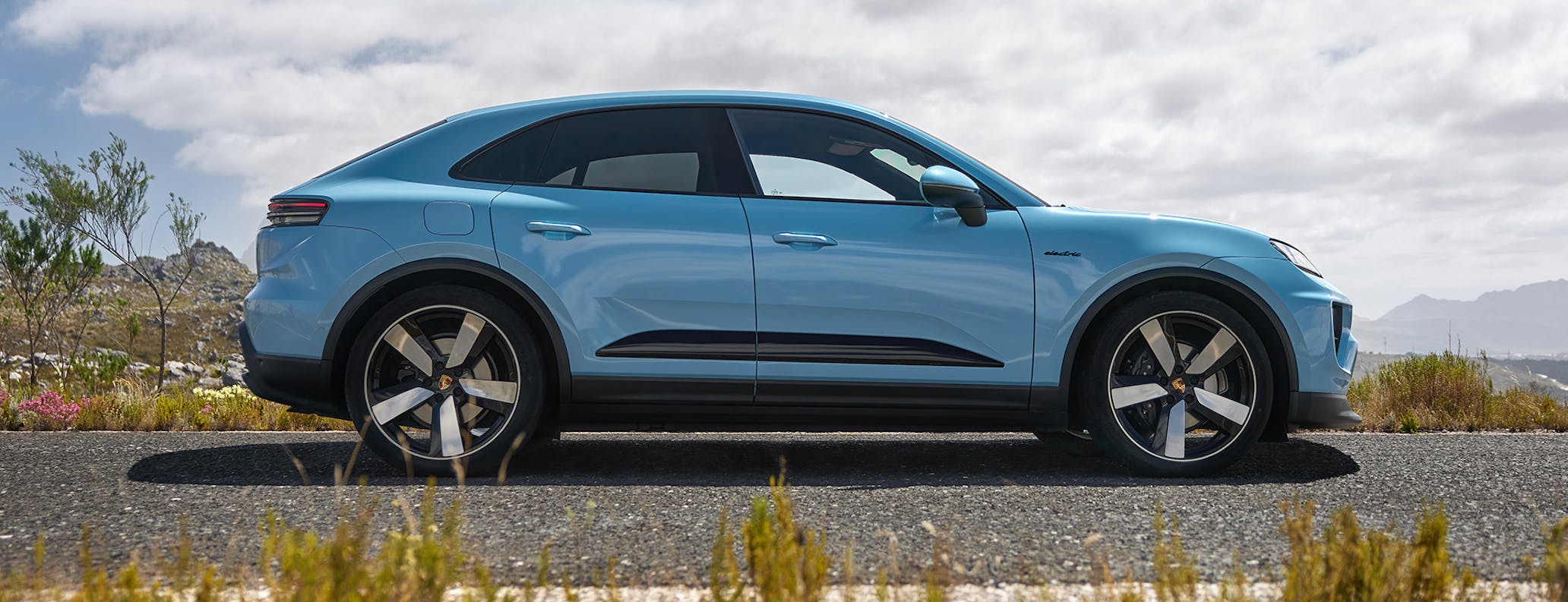 Porsche Macan Electric in Frozen Blue Metallic parked on road