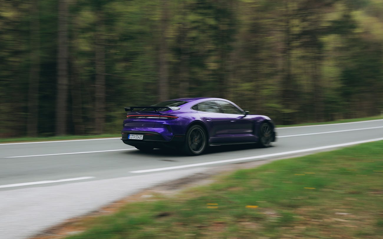 Purple Taycan Turbo GT driving on scenic forest road