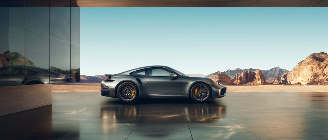 Porsche 911 Turbo S (type 992.2) parked side on with mountains in background