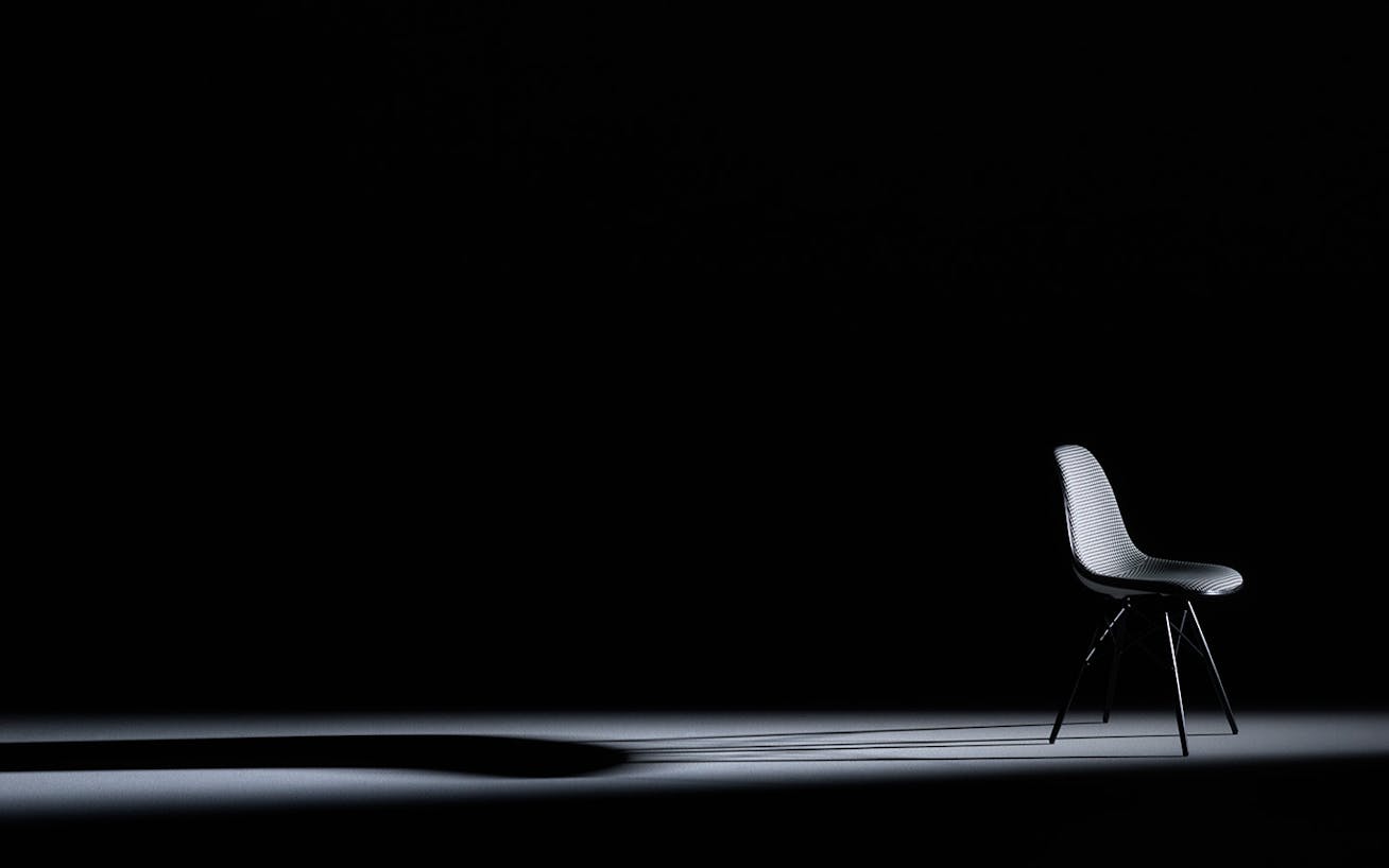 Eames Plastic Side Chair Pepita Edition on black background 