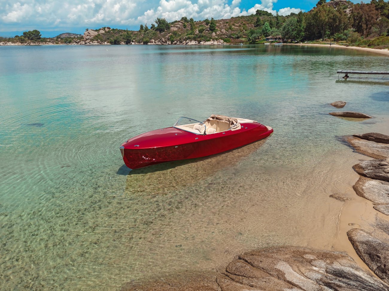 Red Hermes Speedster moored in clear waters of an inlet