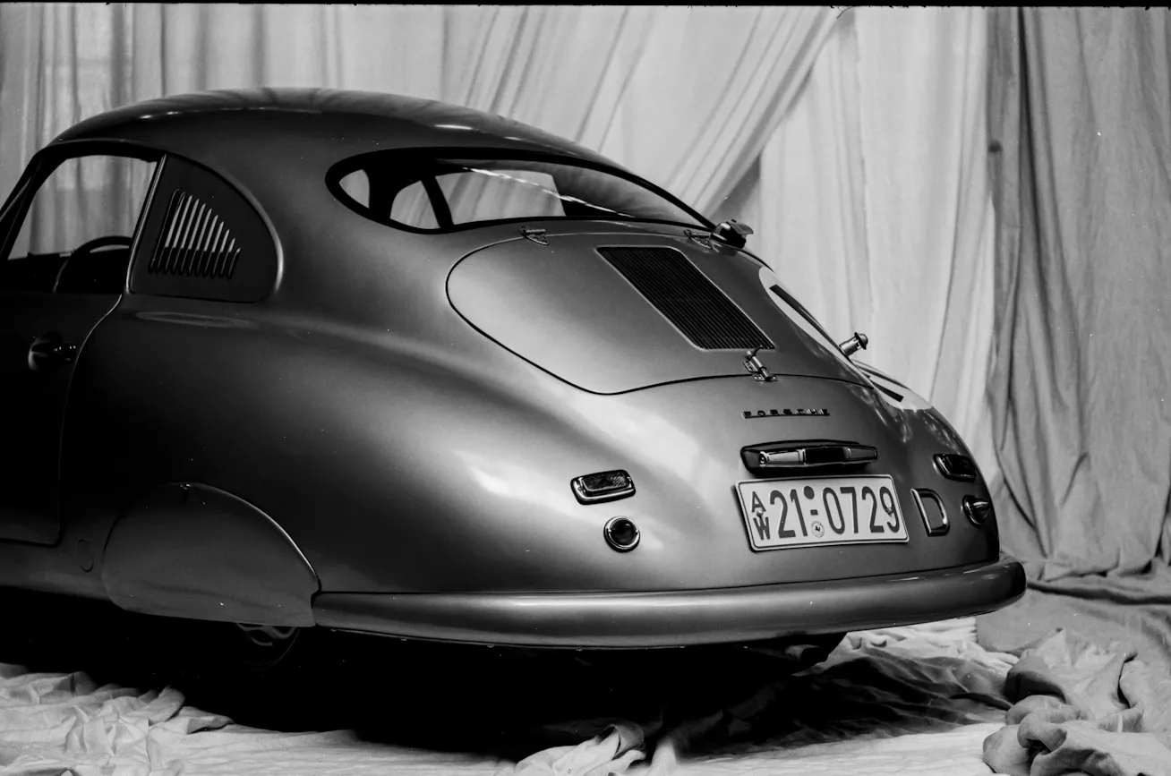 Image 2 Rear three-quarter view Porsche 356 SL beside curtains