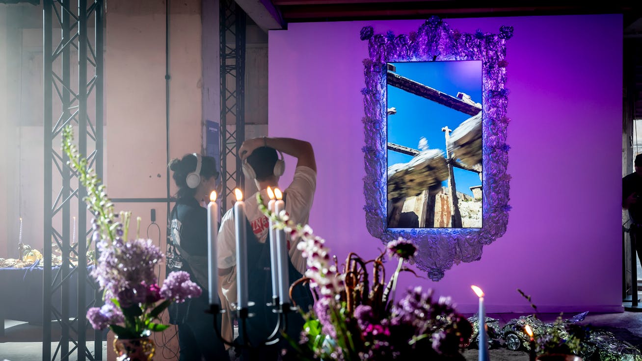 Two visitors looking at an augmented reality artwork at Porsche SCOPES, Marseille
