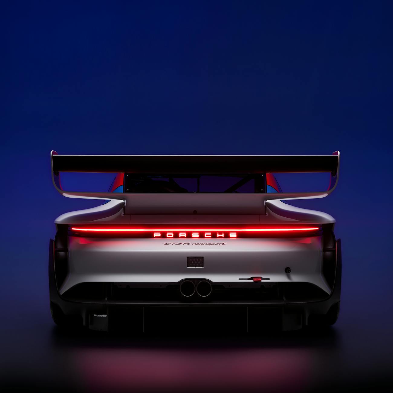 Porsche GT3 R rennsport race car, rear view with illuminated taillights