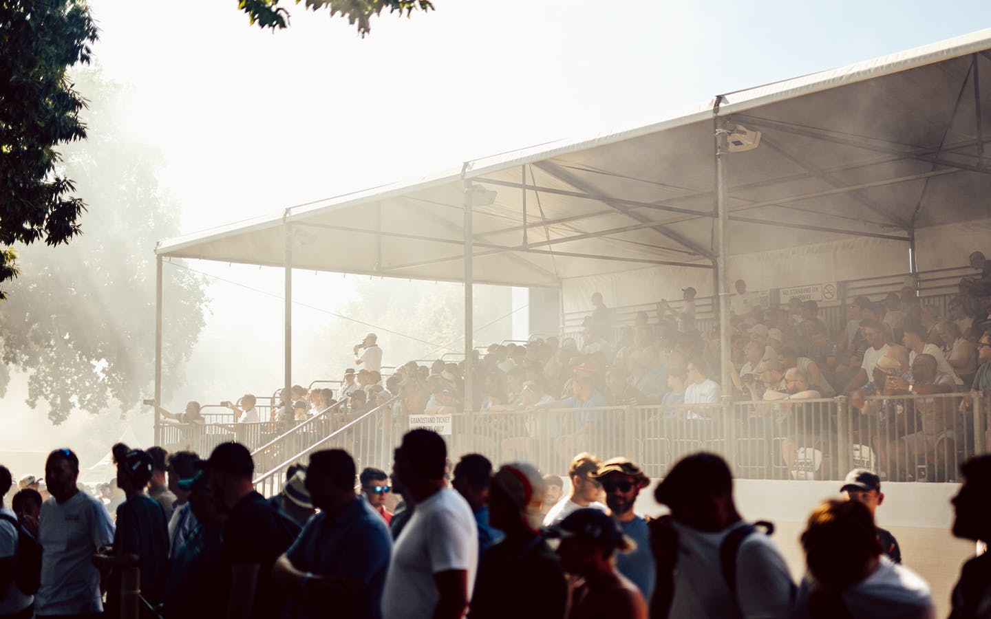 Smoke wafts around grandstand on Hillclimb at 2025 Goodwood Festival of Speed