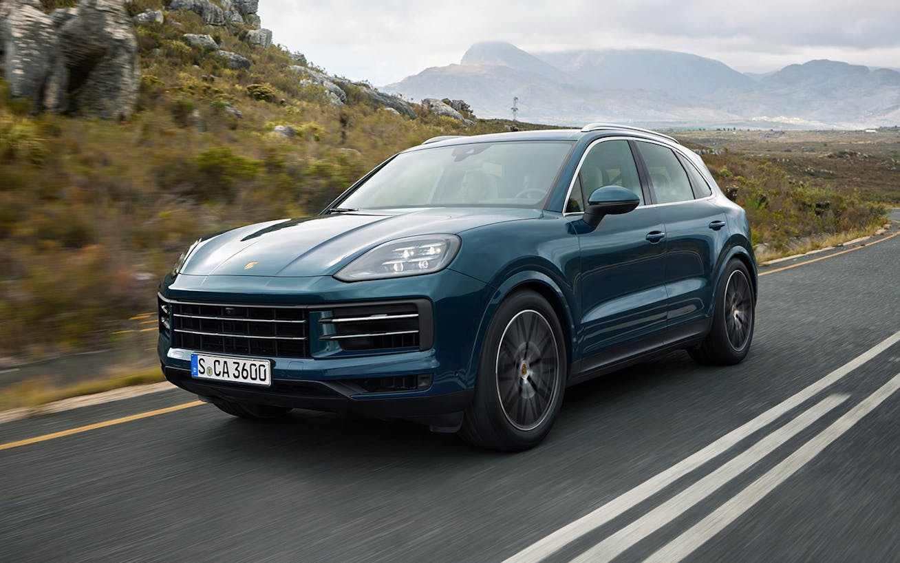 Porsche Cayenne on the road in hilly countryside