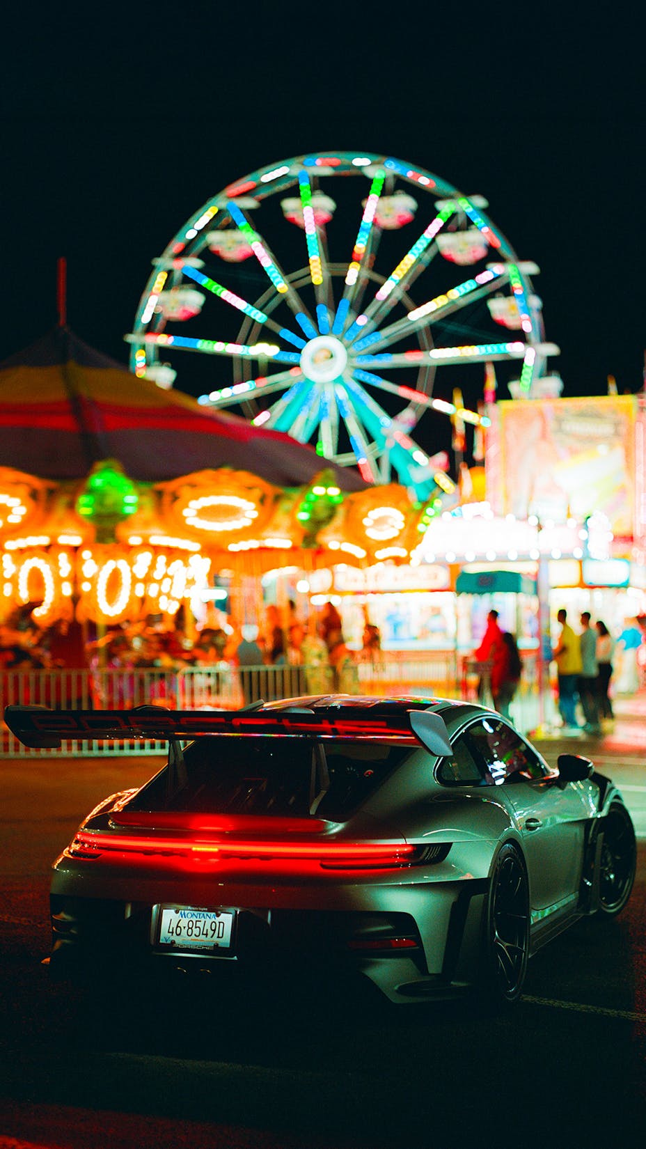 Porsche 911 GT3 RS at a funfair at night  