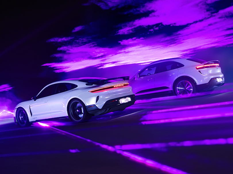 Porsche Taycan Turbo with Weissach package and Macan Turbo Electric lit by lasers