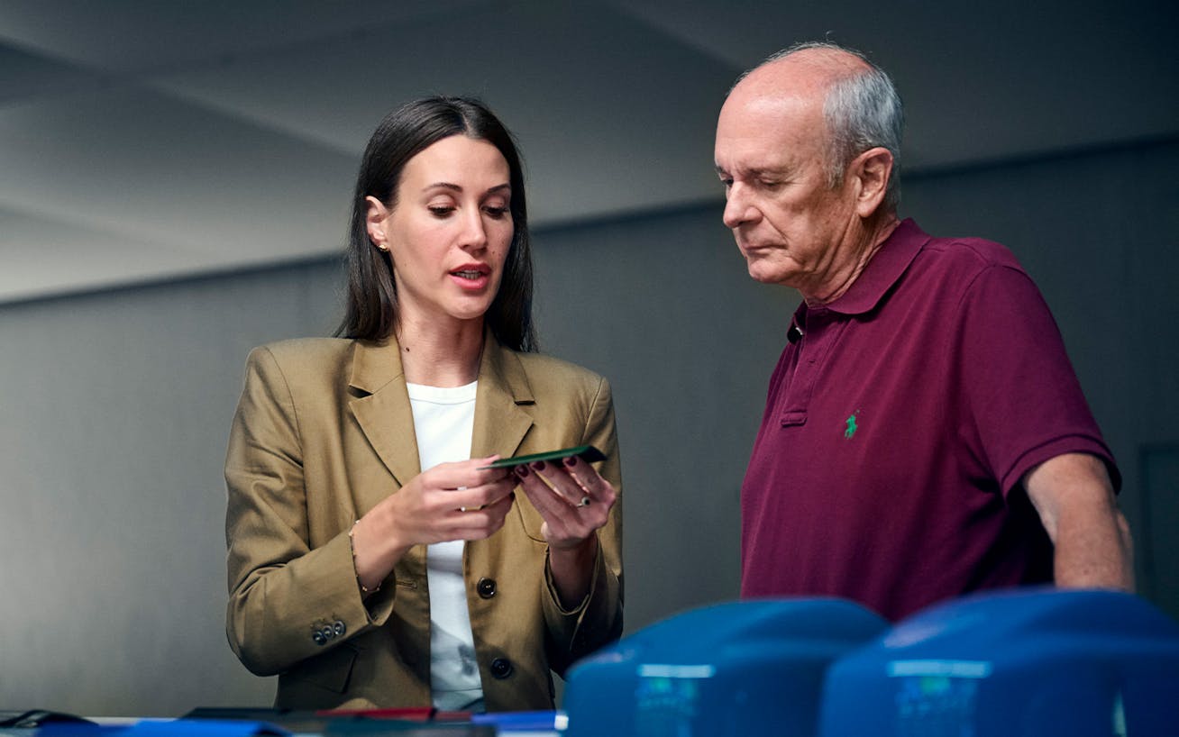 Woman presenting colour samples to man during design consultation