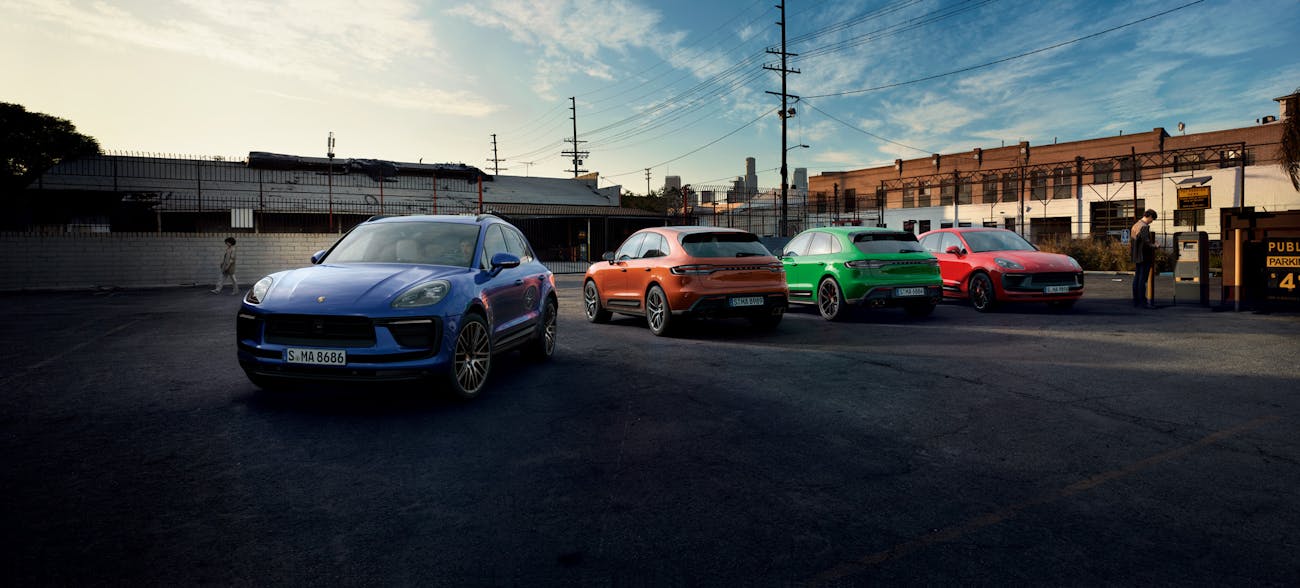 Colourful line-up of the Porsche Macan range in urban location