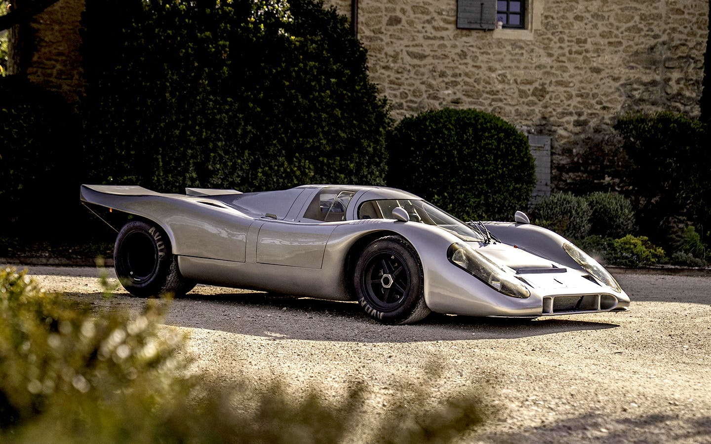 Porsche 917 KH Street outside farmhouse-style building