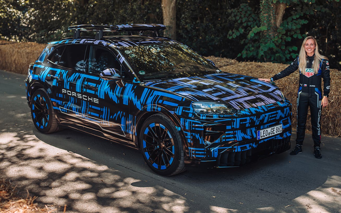 Gabriela Jílková standing next to camouflaged Porsche Cayenne Electric 