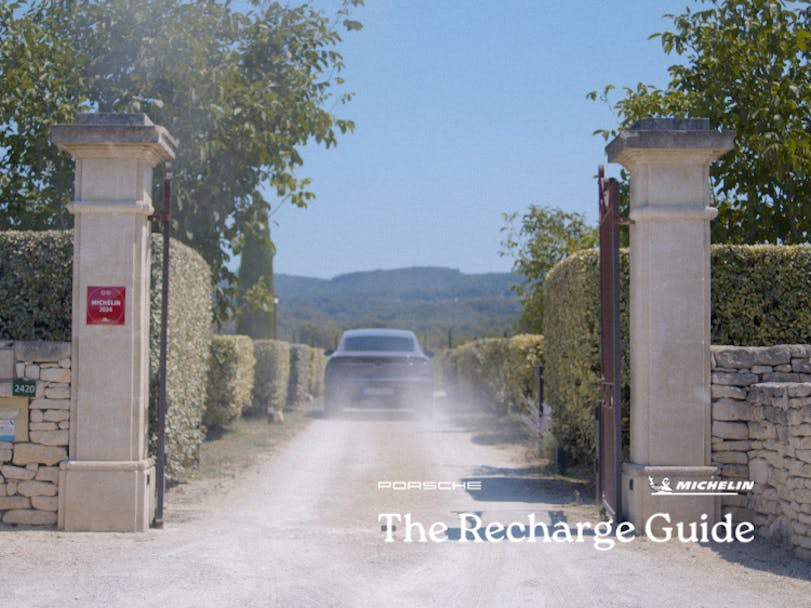 Porsche Macan Electric driving up driveway to hotel in Provence