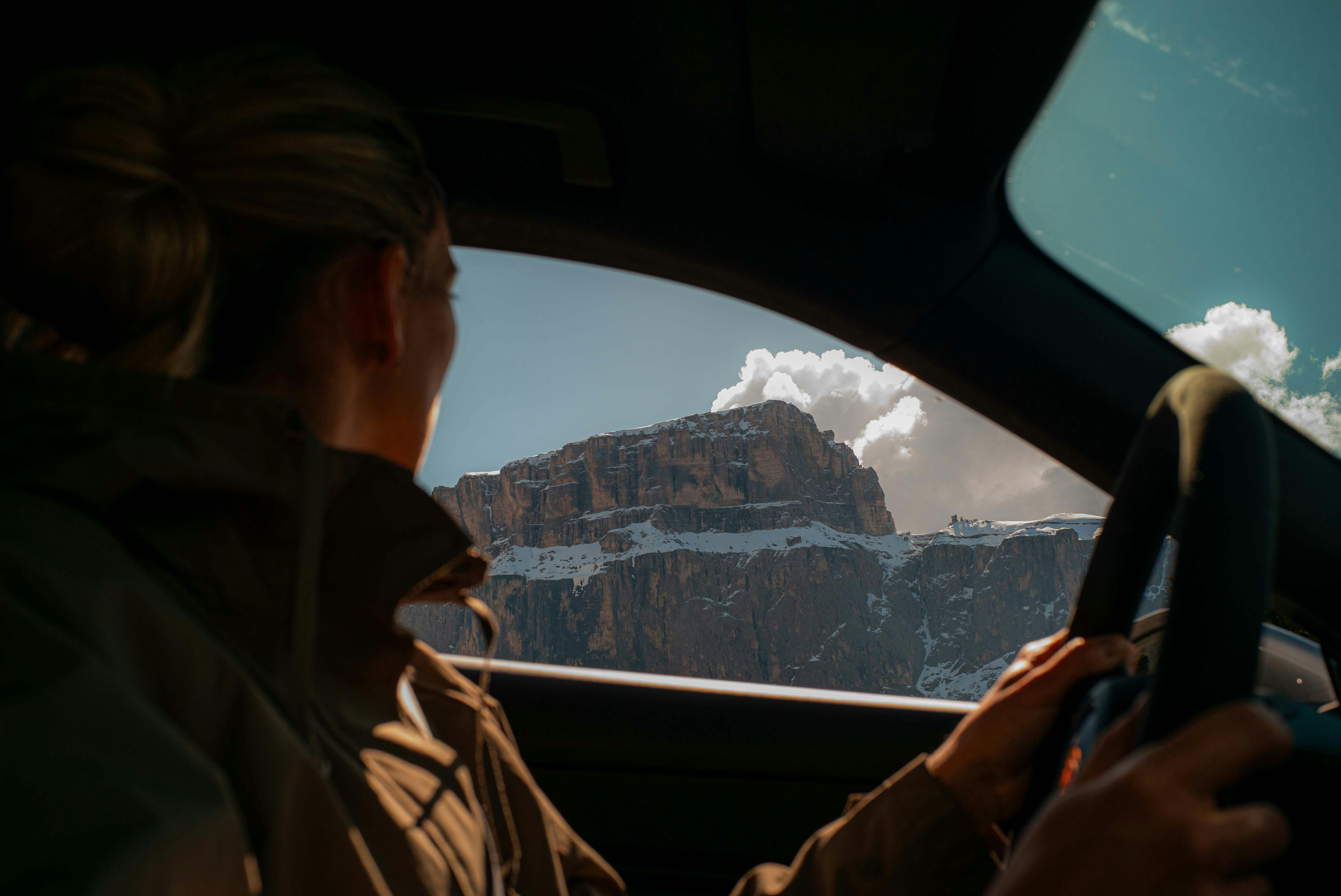 woman driving taycan dolomites