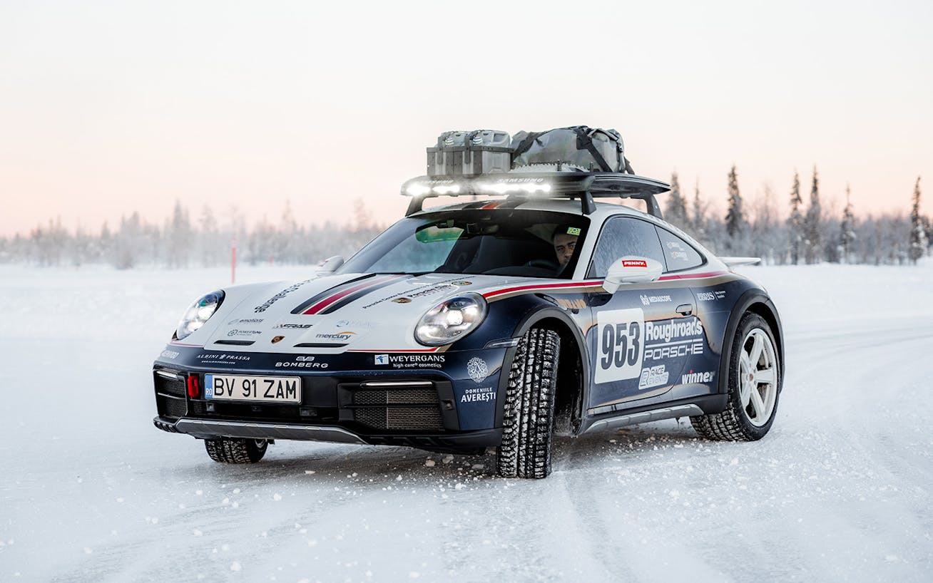 Porsche 911 Dakar with roof cage driving on snow