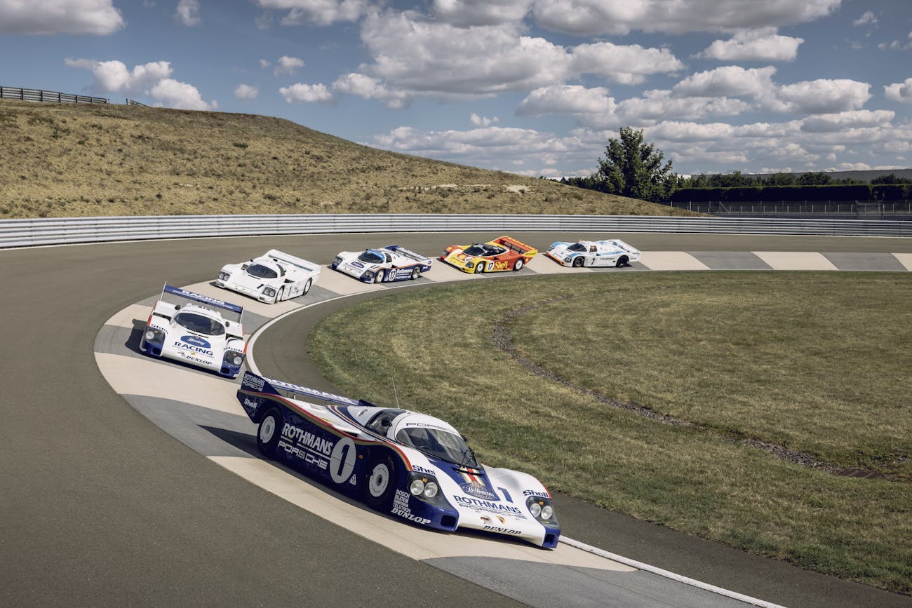 Group C Porsche cars cornering at a racetrack