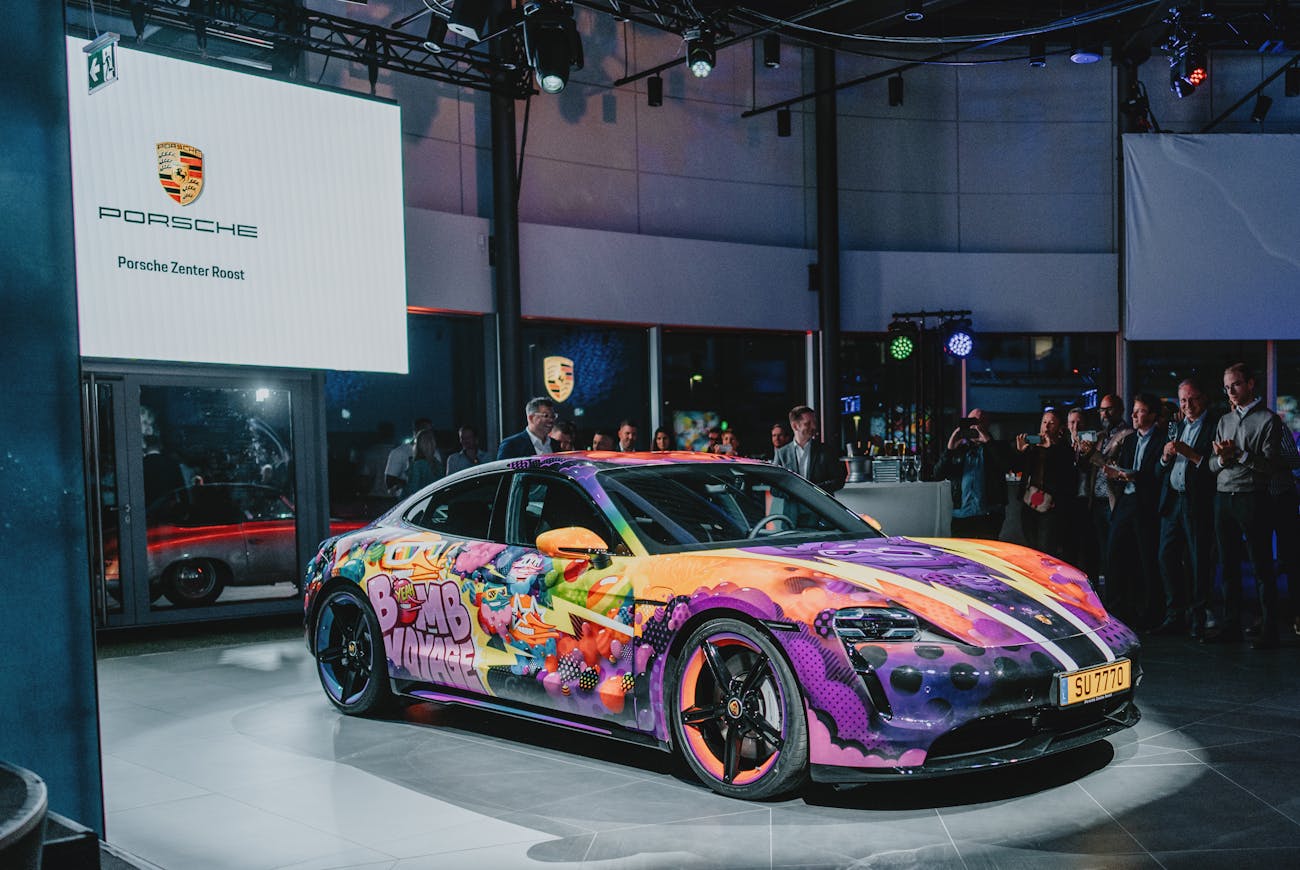 Multi-coloured electric Taycan art car in showroom 