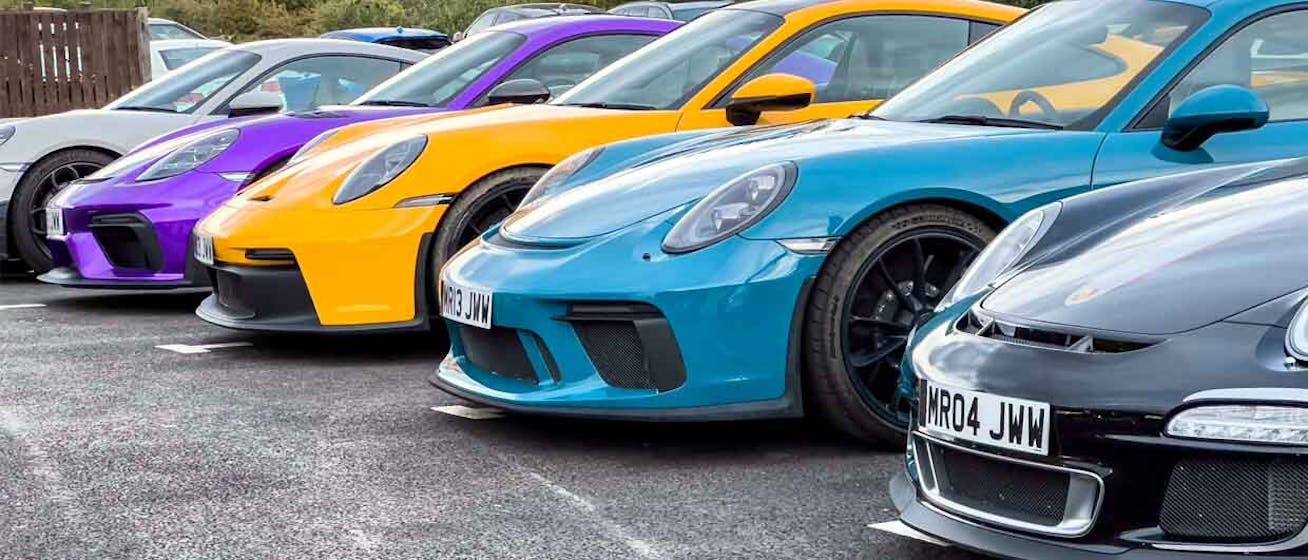 Row of Porsche 911 GT3 sportscars parked side by side