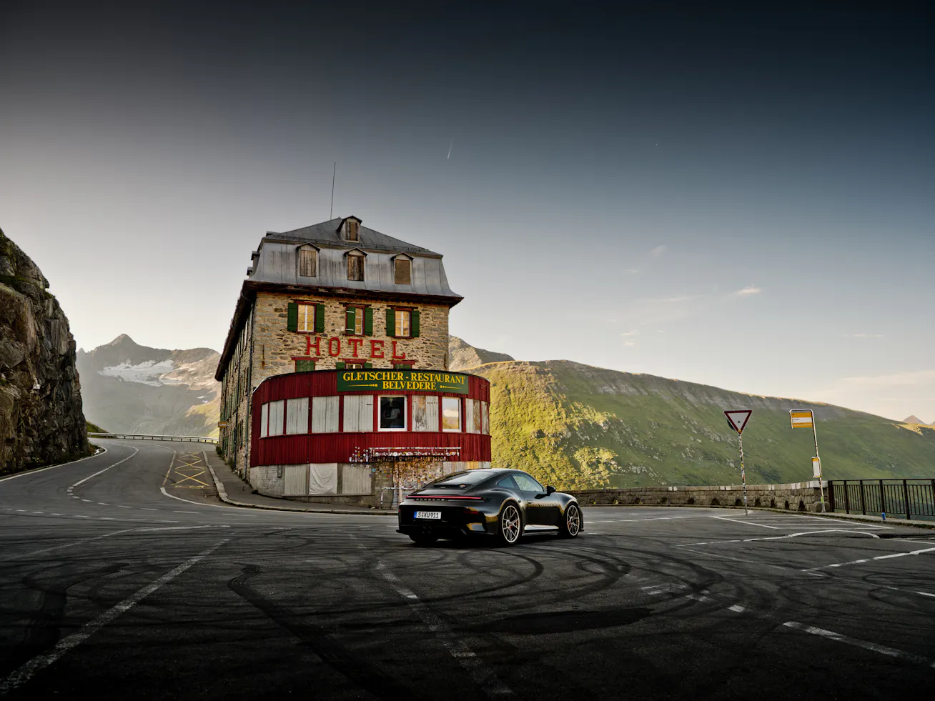 Porsche GT3 Bergsport driving past the historic Hotel Belvédère on the iconic Furka Pass in Switzerland