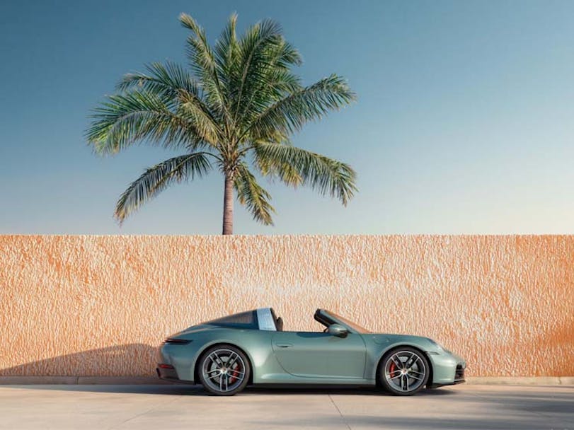 Porsche 911 Targa (type 992.2) pictured against a wall with palm tree in background