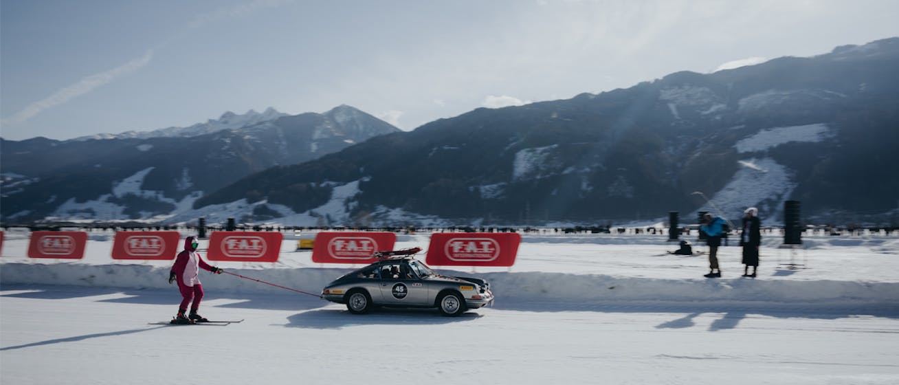 Man skiing behind Porsche 911 at the F.A.T. Ice Race