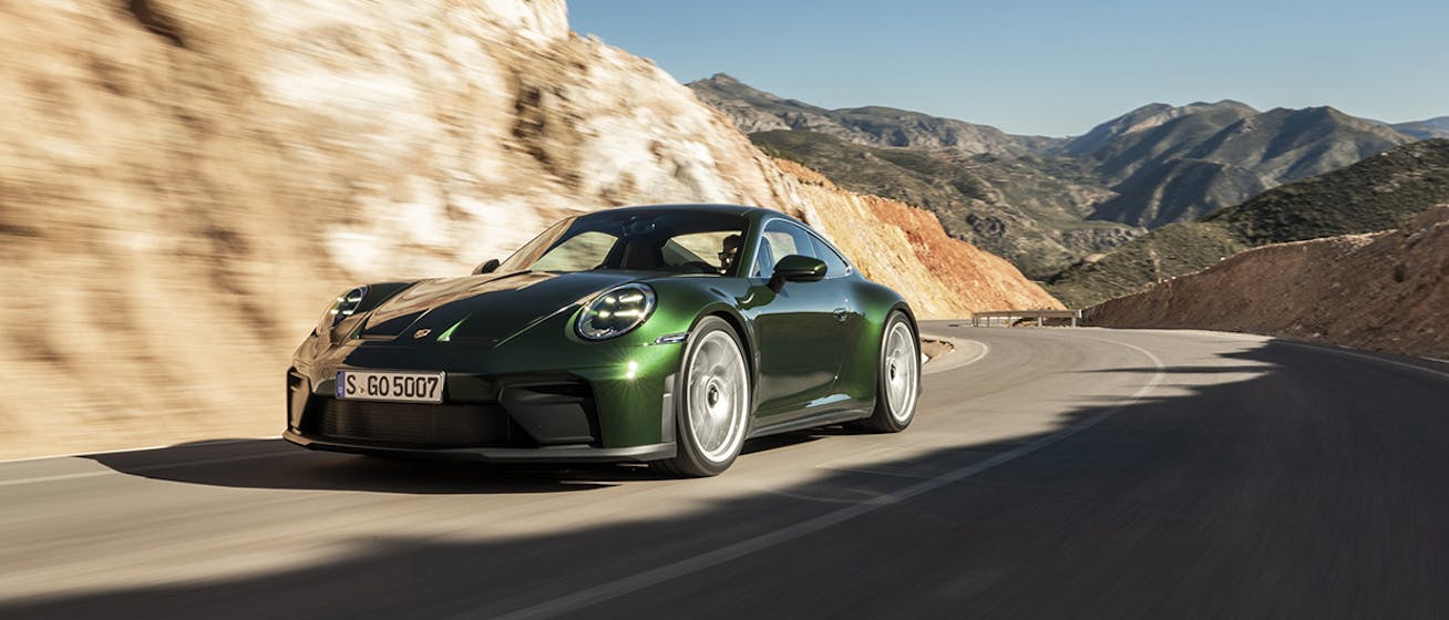 911 GT3 with Touring Package driving on sunny mountain road