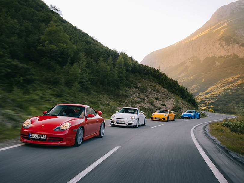 Four generations of Porsche 11 GT3 on mountain road