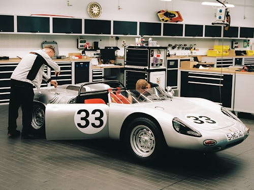 Technicians work on Porsche 718 W-RS Spyder at Porsche Museum