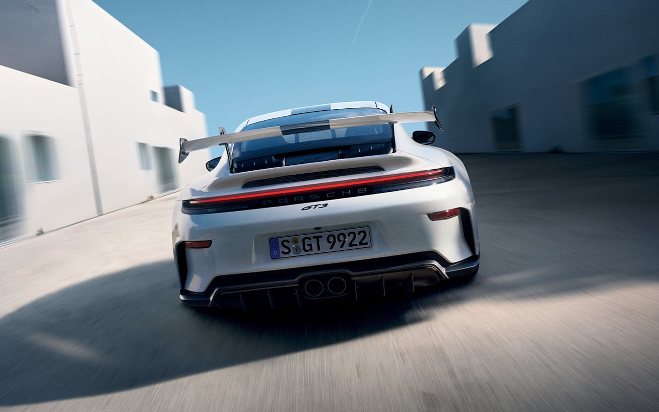 Rear wing view of white 2024 Porsche 911 GT3