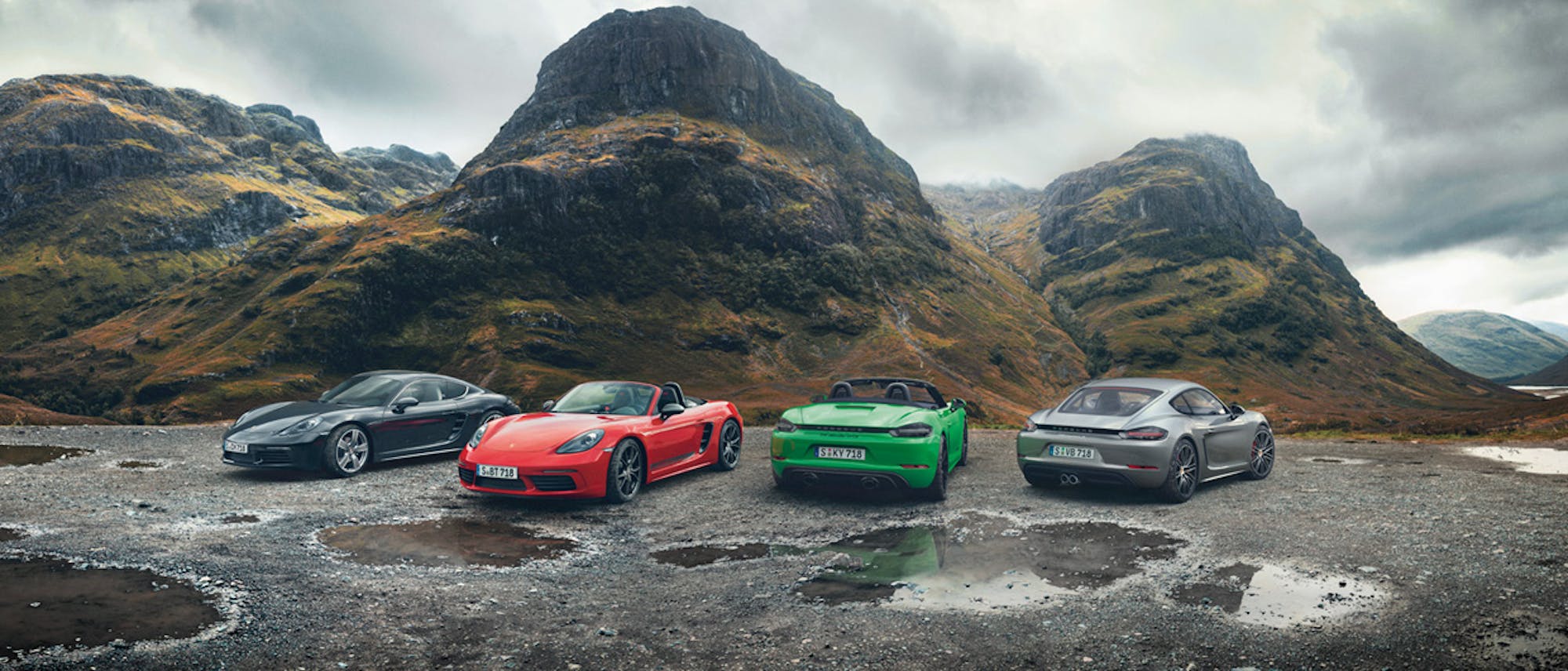 Porsche 718 range in front of rugged hills and grey sky