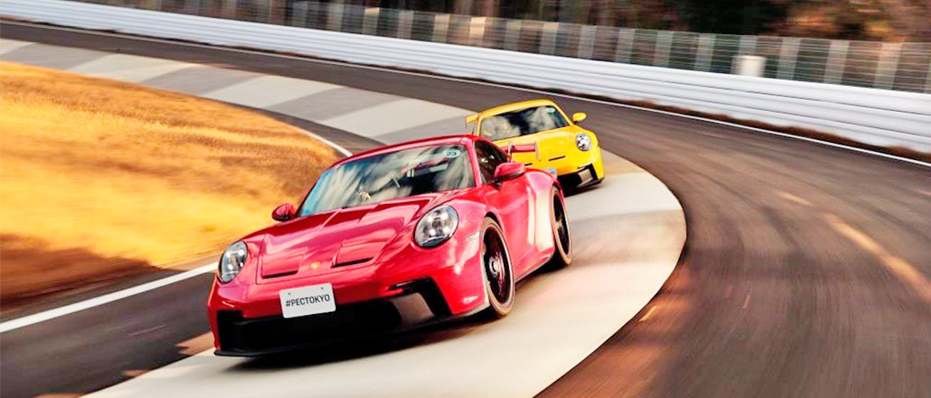 Two Porsche 911 sportscars on track at Porsche Experience Center Tokyo