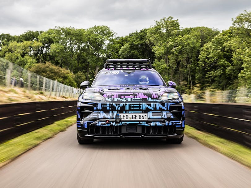 Camouflaged near-production Porsche Cayenne Electric driving on track 