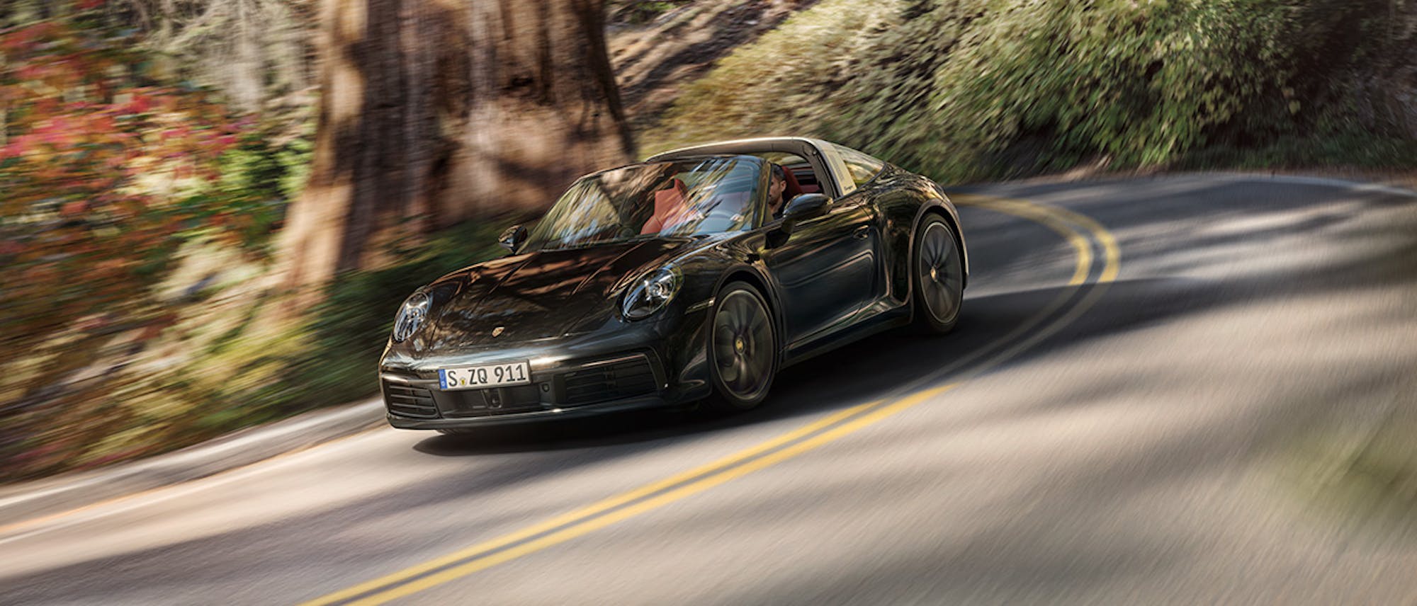 Jet Black Metallic 911 Targa 4S on forest road