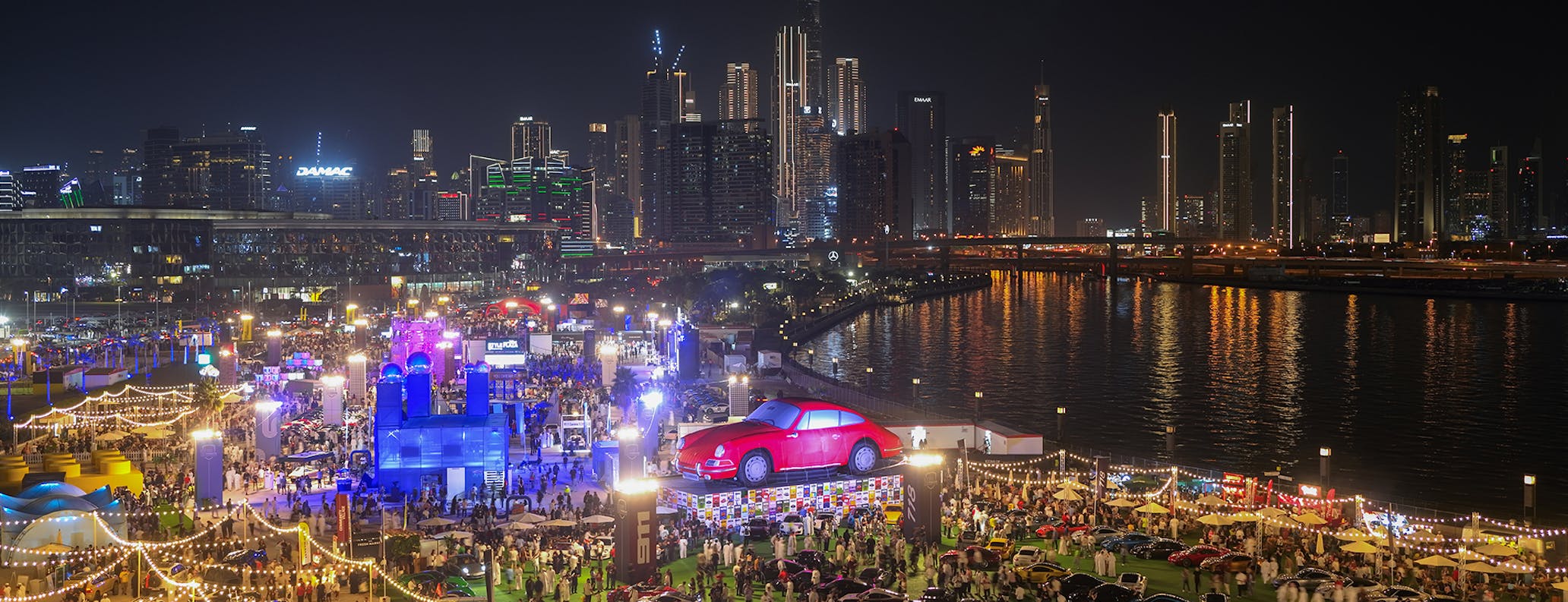 Life-sized red classic Porsche 911 display at the 2025 Icons of Porsche in Dubai 