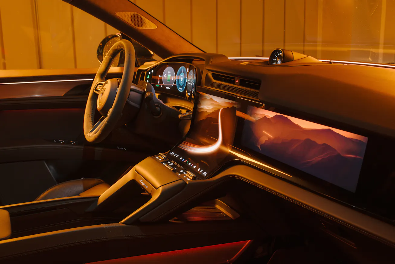 Interior image of Porsche Cayenne Electric showing driver’s side and central screen
