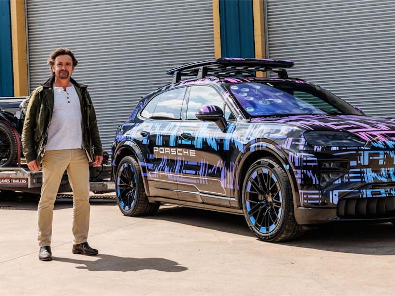 Former Top Gear presenter Richard Hammond with the new Porsche Cayenne Electric and trailer with classic car in background