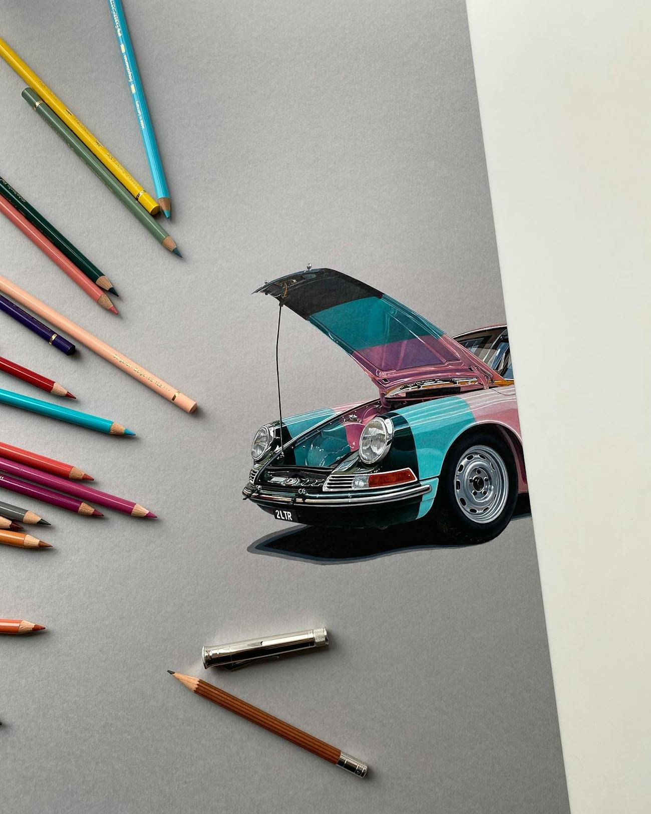 Colourful Porsche drawing with hood up – real pencils surrounding it