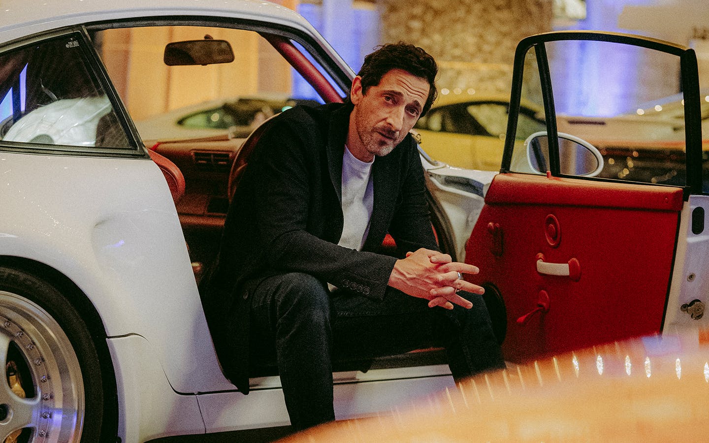 Actor Adrien Brody sat in classic Porsche 911 at 2025 Goodwood Festival of Speed
