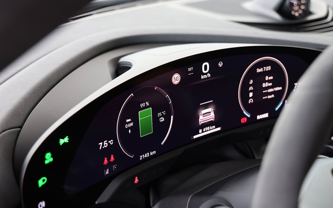 Close-up of driver display showing charge level on Porsche Taycan