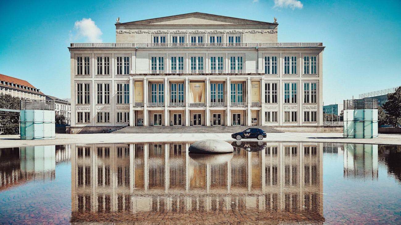 Leipzig Opera House reflected in the water feature outside
