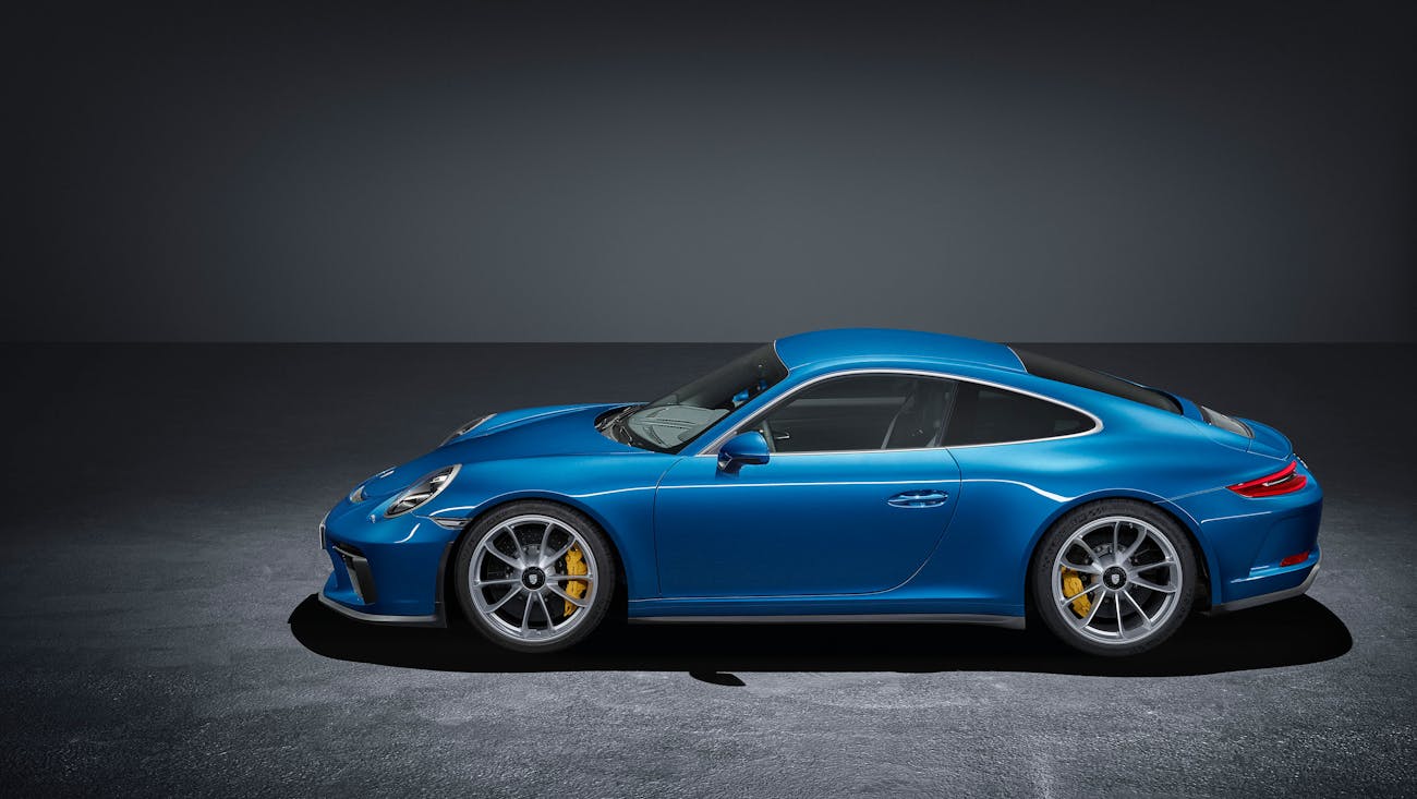 Blue Porsche 911 GT3 Touring (type 991) in a studio